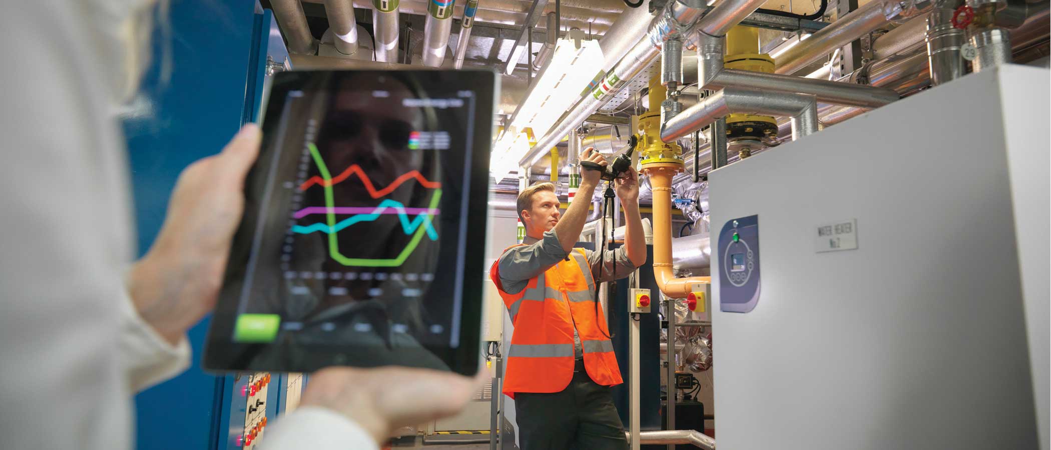 Workers use automation to manage the physical plant of a modern building.